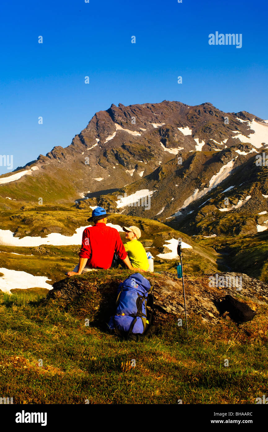A father and son backpacking near Hatcher Pass in the Talkeetna Mountains, Southcentral Alaska, Summer Stock Photo