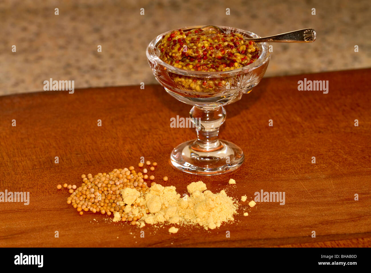 Mustard, prepared whole grain, yellow seeds, and dried powdered hot mustard Stock Photo