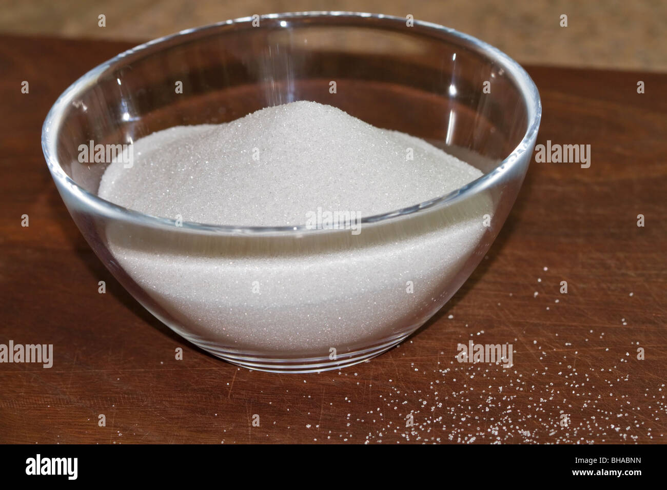 Granulated sugar in a glass bowl Stock Photo