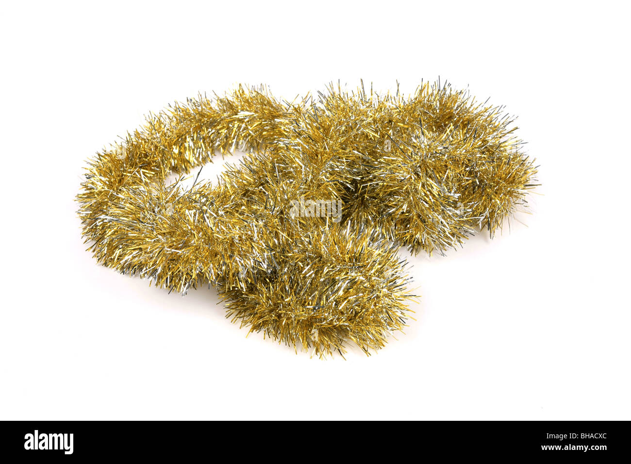 Gold Tinsel against a white background Stock Photo