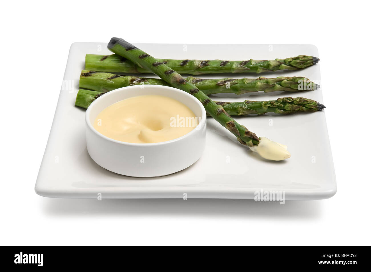 Asparagus spears on a plate, with a mayonnaise dip Stock Photo Alamy