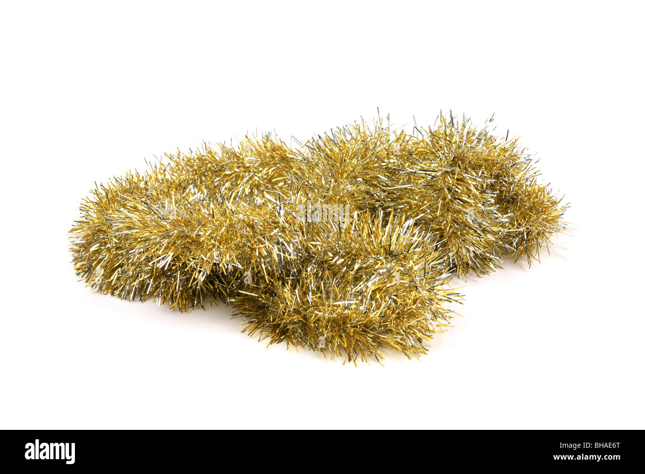 Gold Tinsel against a white background Stock Photo