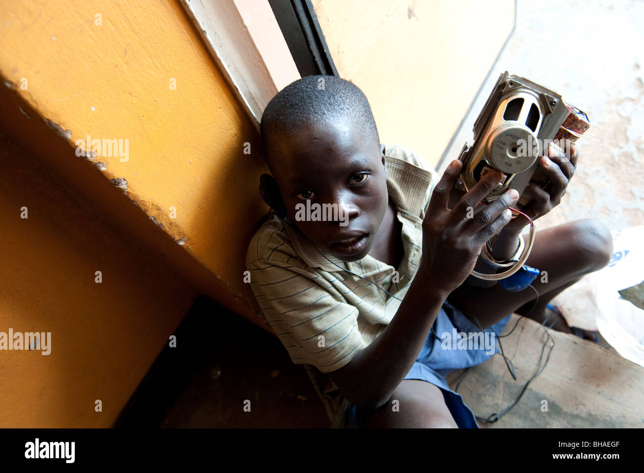 Homeless boy with home made radio in Kampala Uganda Stock Photo