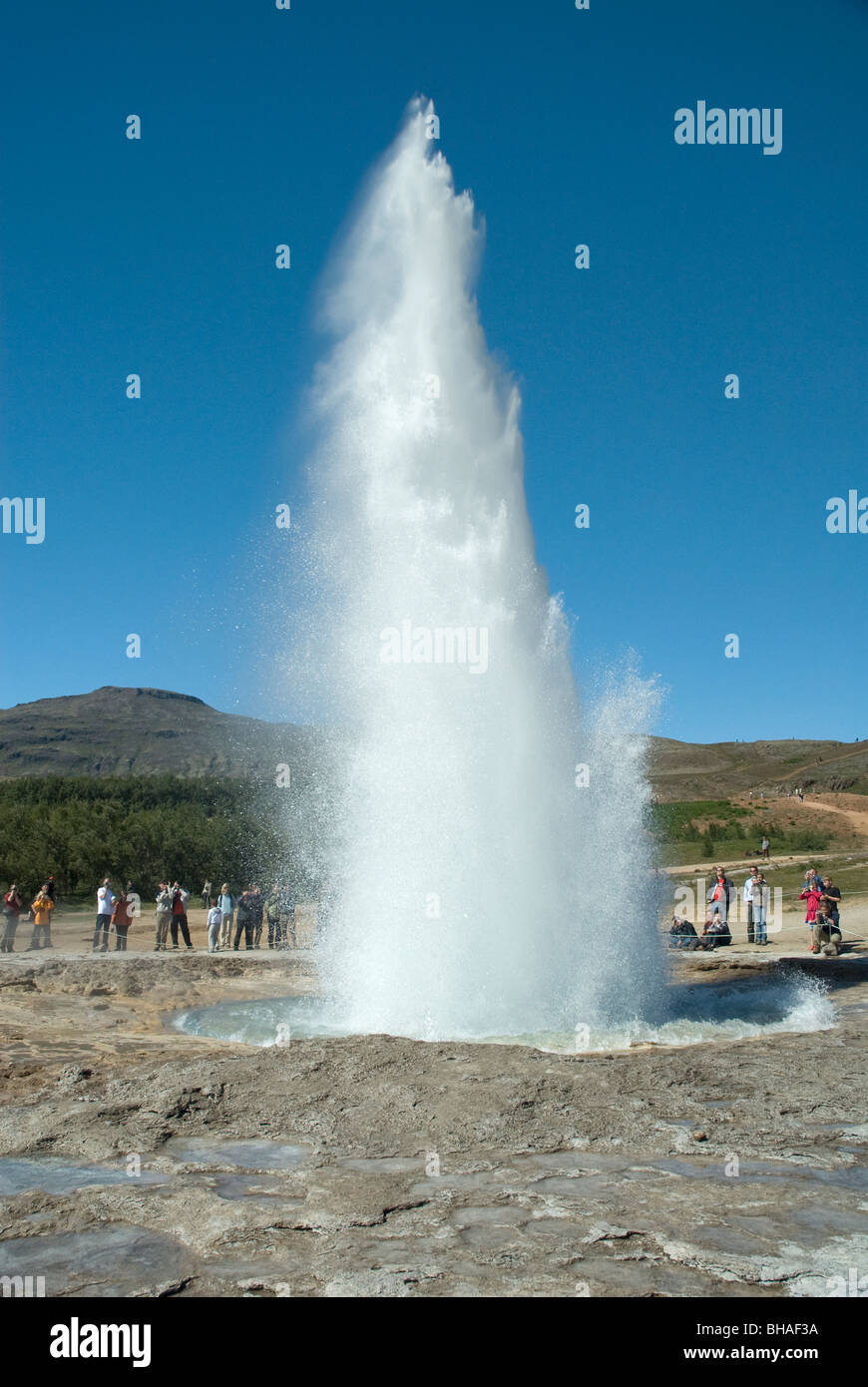 A group of people watching Strokkur Geysir erupt, Haukadalur, Iceland Stock Photo