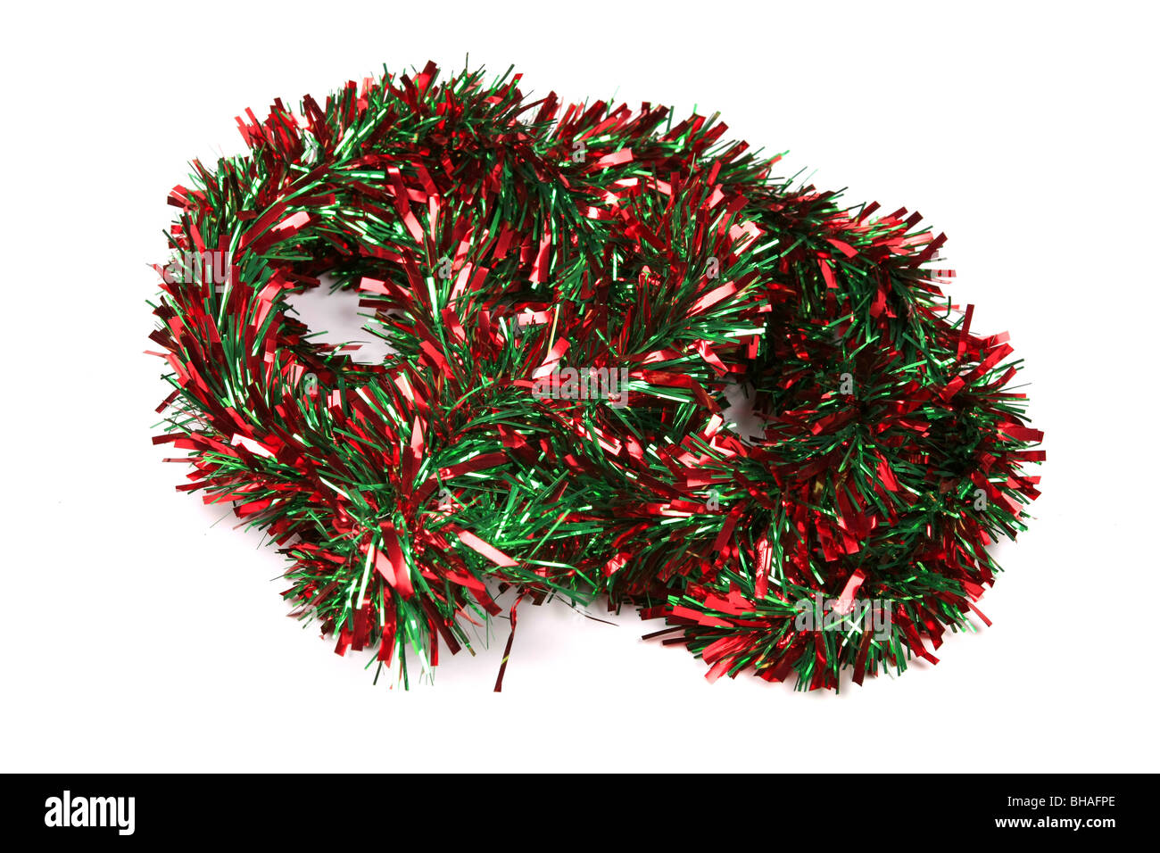 Red and Green Tinsel against a white background Stock Photo