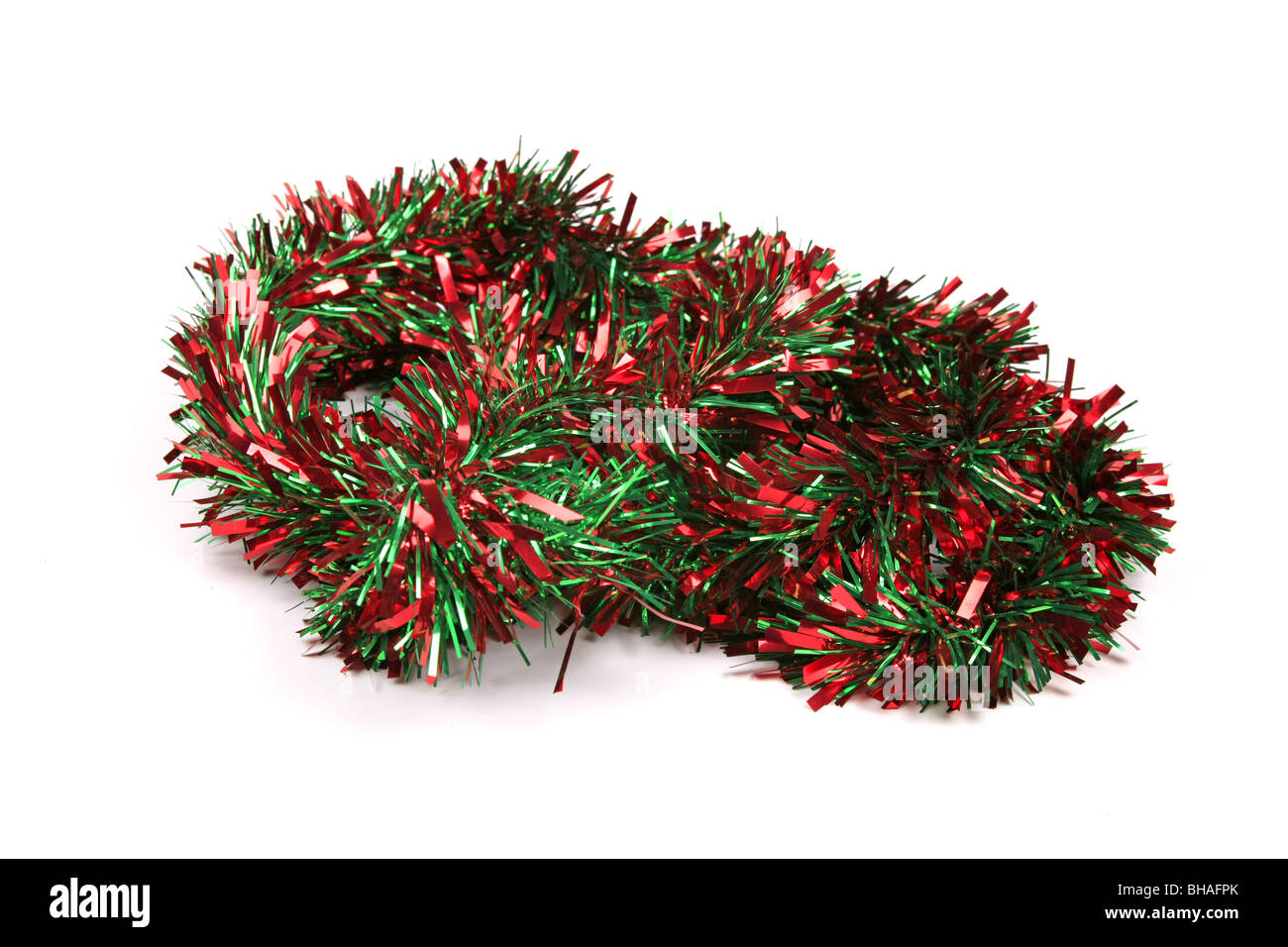 Red and Green Tinsel against a white background Stock Photo