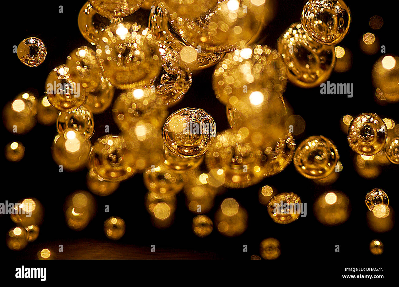 Golden bubbles in a block of clear plastic Stock Photo Alamy