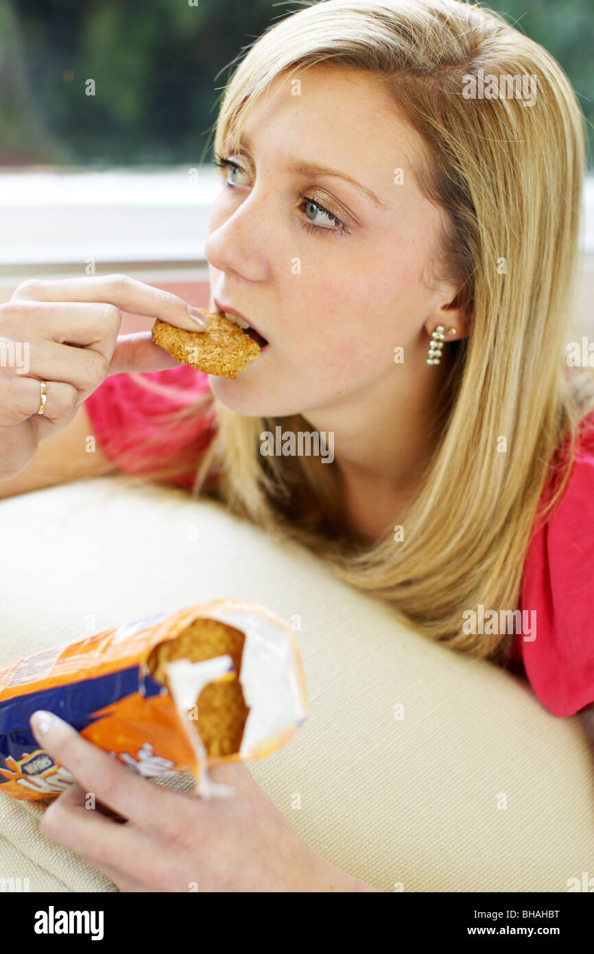 Teen girl eating biscuits Stock Photo