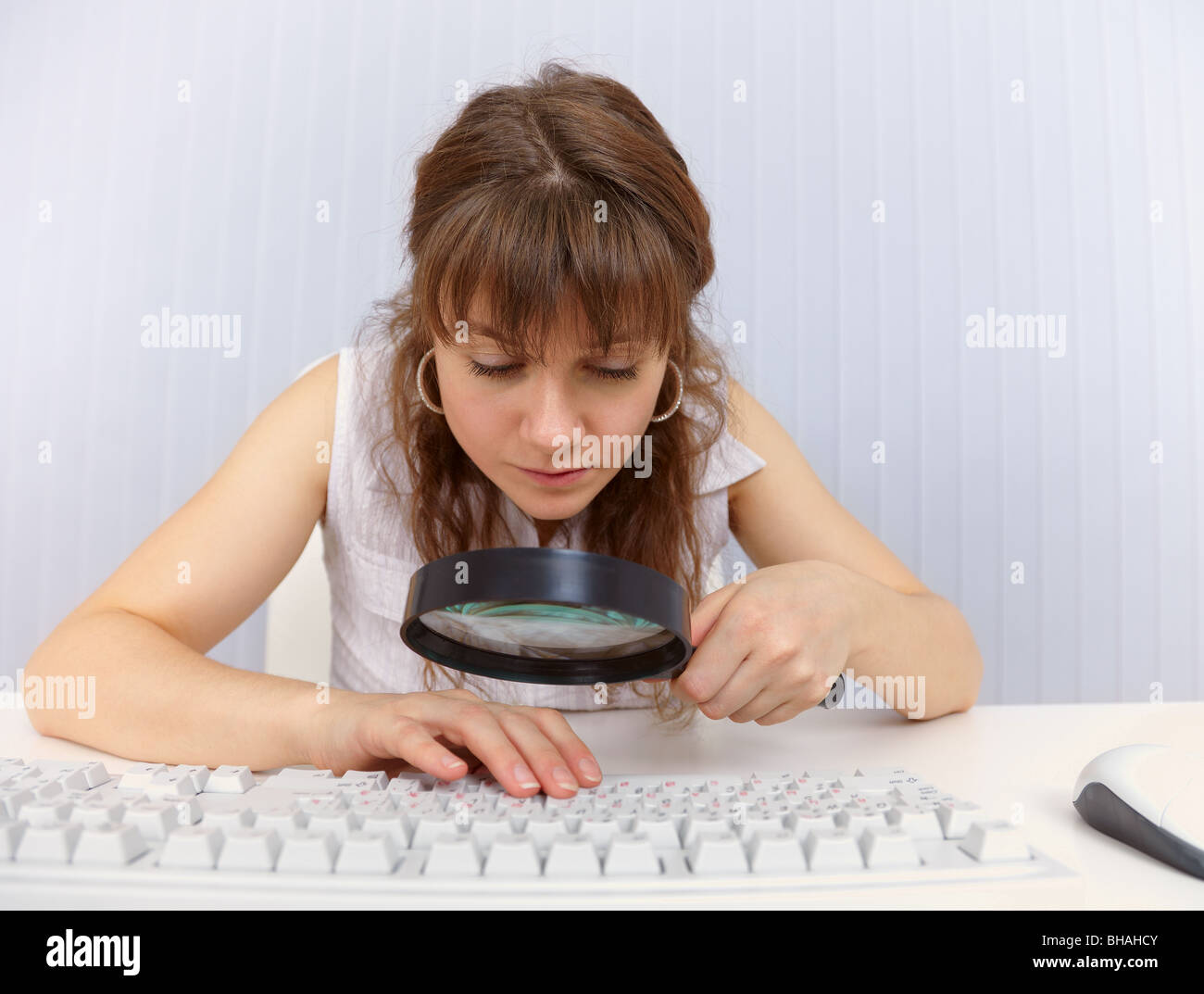 A woman with poor eyesight to work with the computer keyboard Stock ...