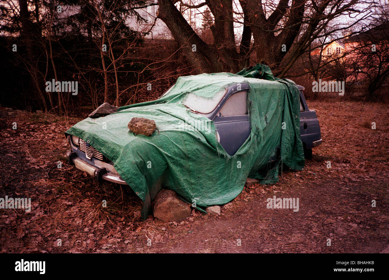 Old Saab that nobody seems to care about Saab V4 Combi under a tarp Stock Photo