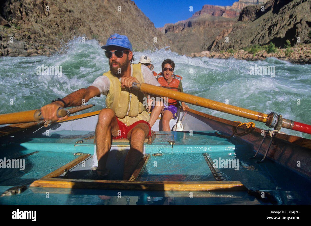 Boatman rowing a dory through rapids on the Colorado River, Grand