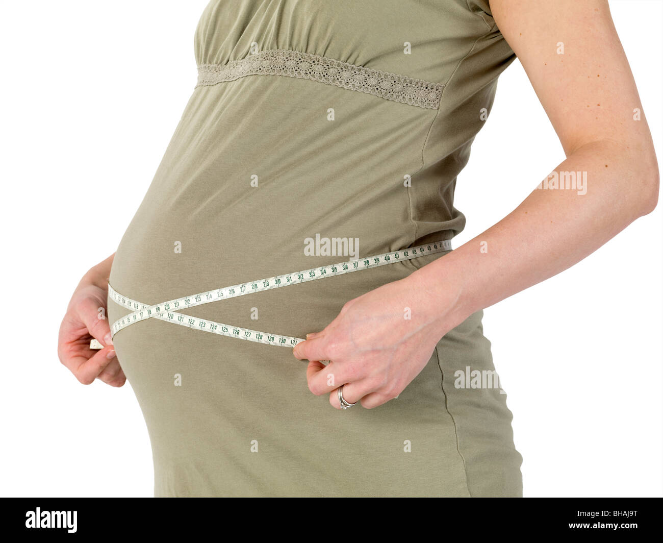 Pregnant woman measures her belly with a tape measure Stock Photo Alamy