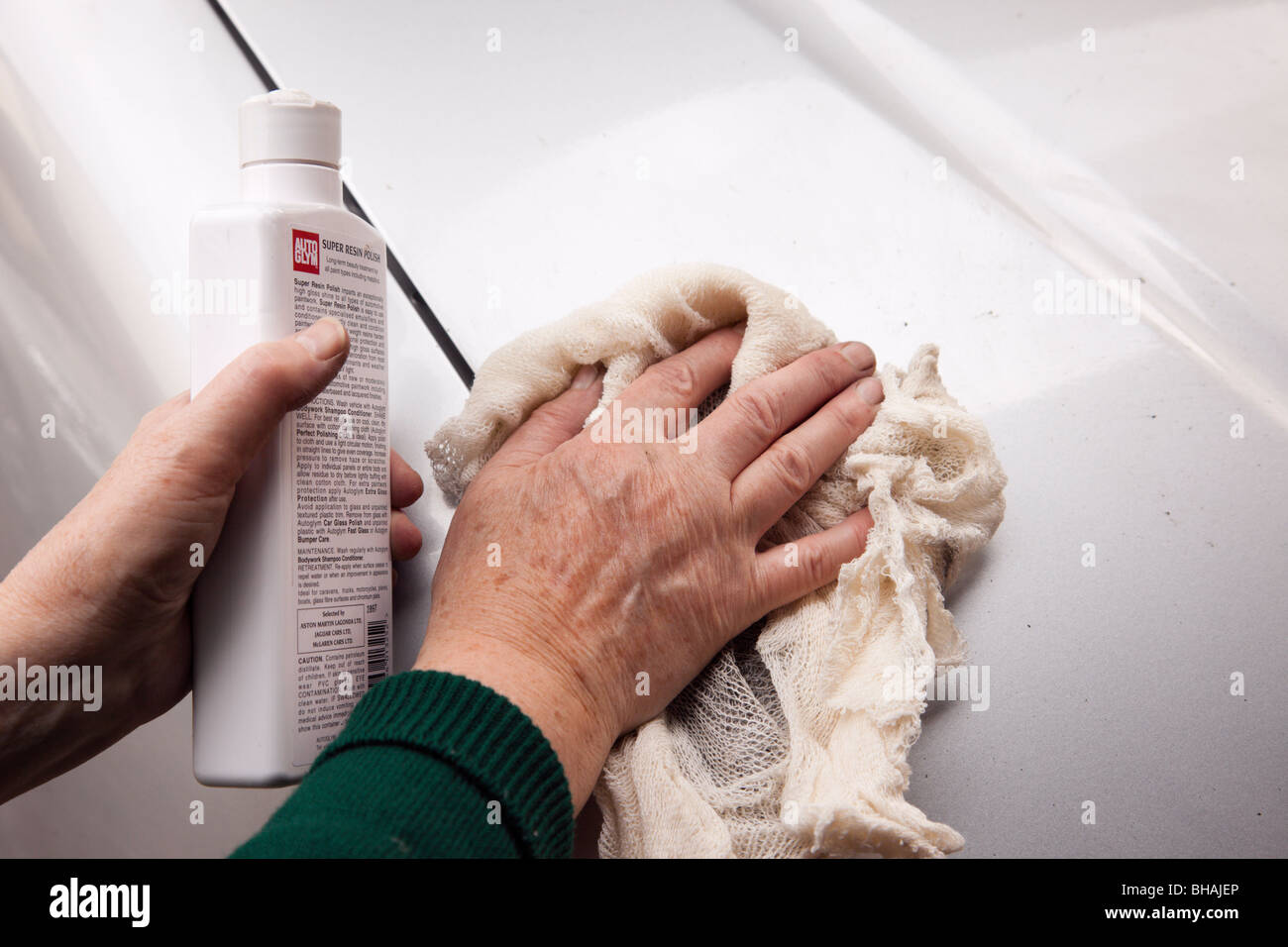 Closeup of a woman cleaning and polishing the bodywork of a car. UK