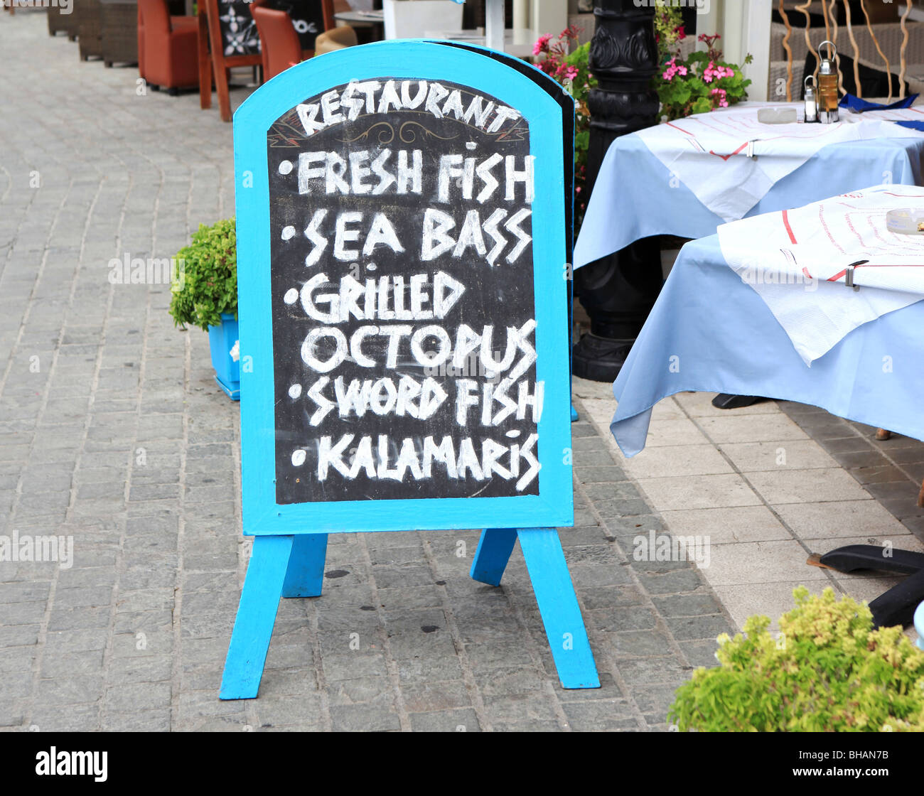 Chalk menu board standing outside of a fish restaurant. This image was taken in Greece. Stock Photo