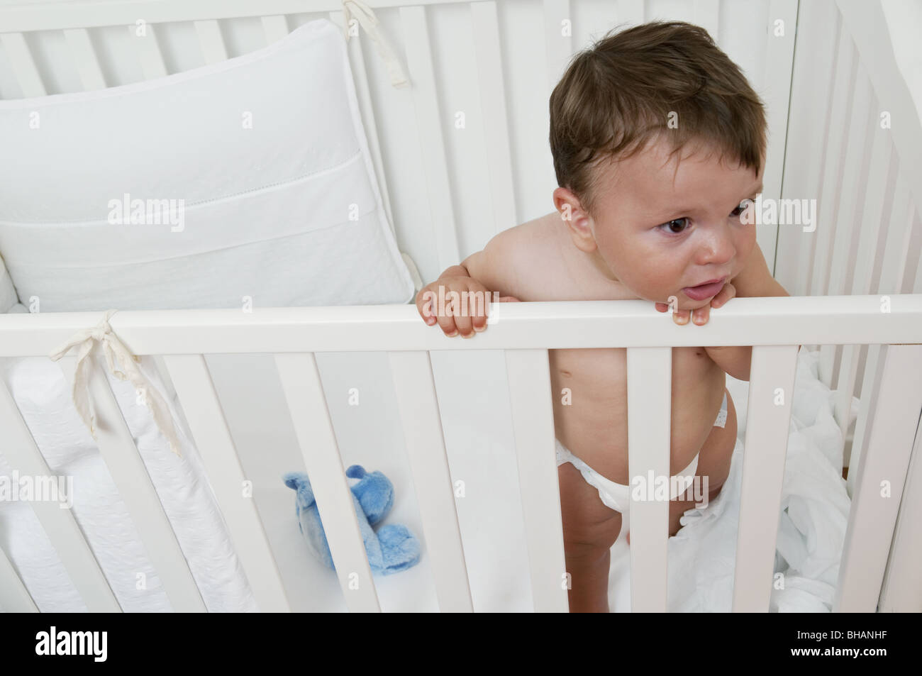 Baby boy in crib upset Stock Photo Alamy