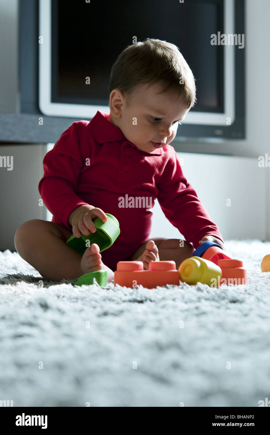 Baby boy playing with toys Stock Photo