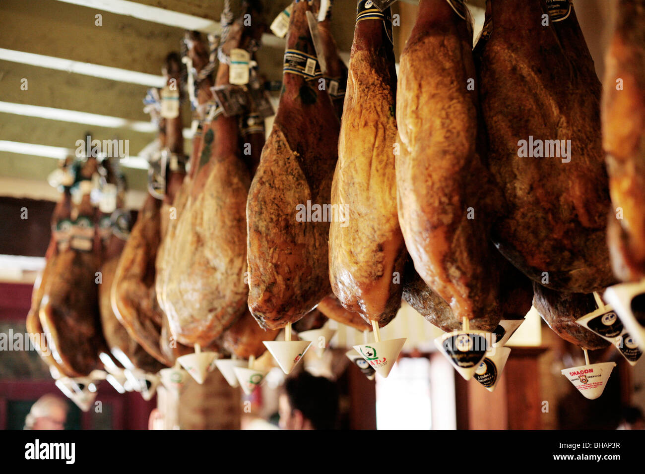 'Jamon Iberico' - Iberian Ham from Acorn fed pigs hanging in a cafe in Seville, Spain. Stock Photo