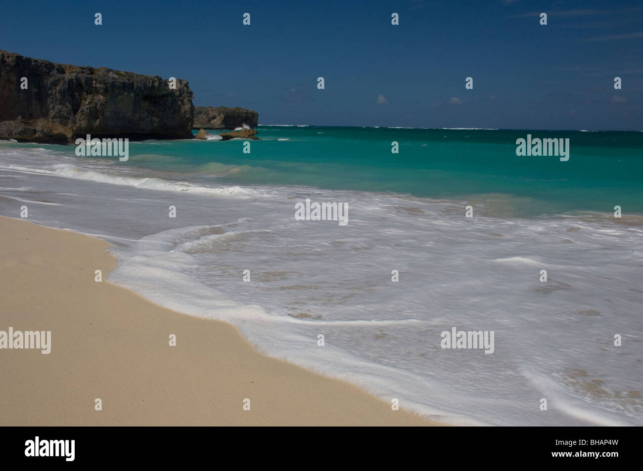 Waves breaking on the white sand beach at Bottom Bay on the east coast of  Barbados in the Caribbean Islands Stock Photo