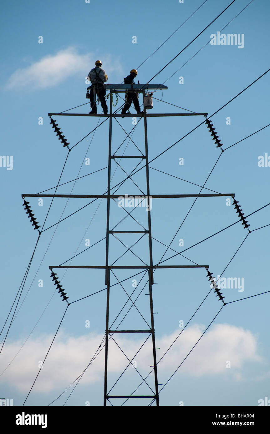 Men working on power lines. Stock Photo