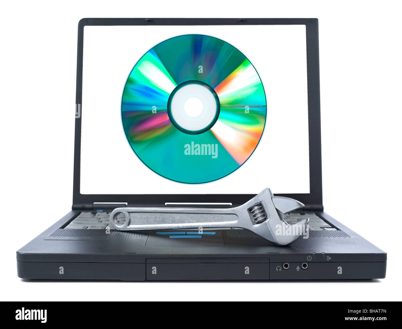 Isolated black laptop with a spanner over it and a digital disc on the screen. Stock Photo