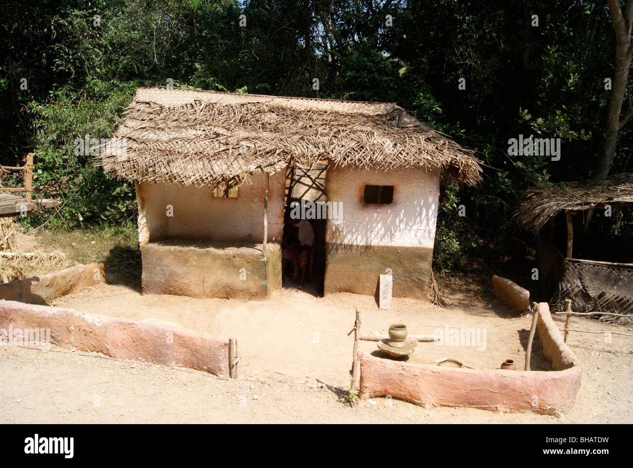 A Poor man Hut in the Village area of India.Coconut leafs arranged in a pattern as roofs.clay mixture is used for construction Stock Photo