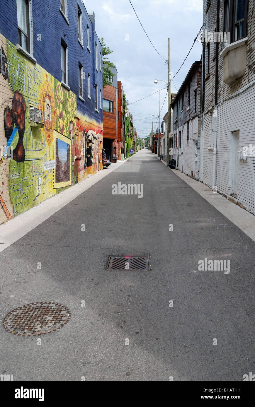 A backstreet in the Kensington market area of Toronto colourfully decorated with modern graffiti Stock Photo