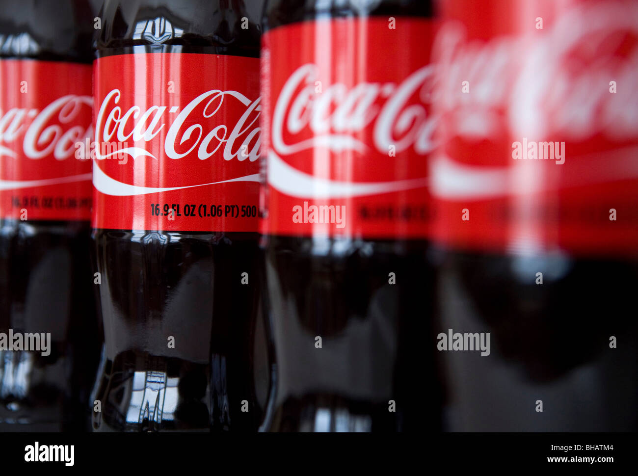 A grouping of Coca-Cola bottles.  Stock Photo