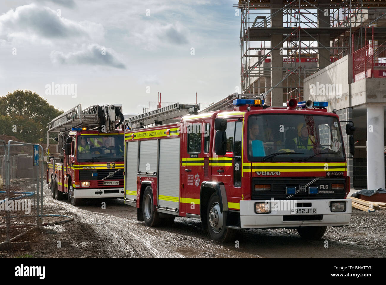 Two fire engines entering a building construction site Stock Photo