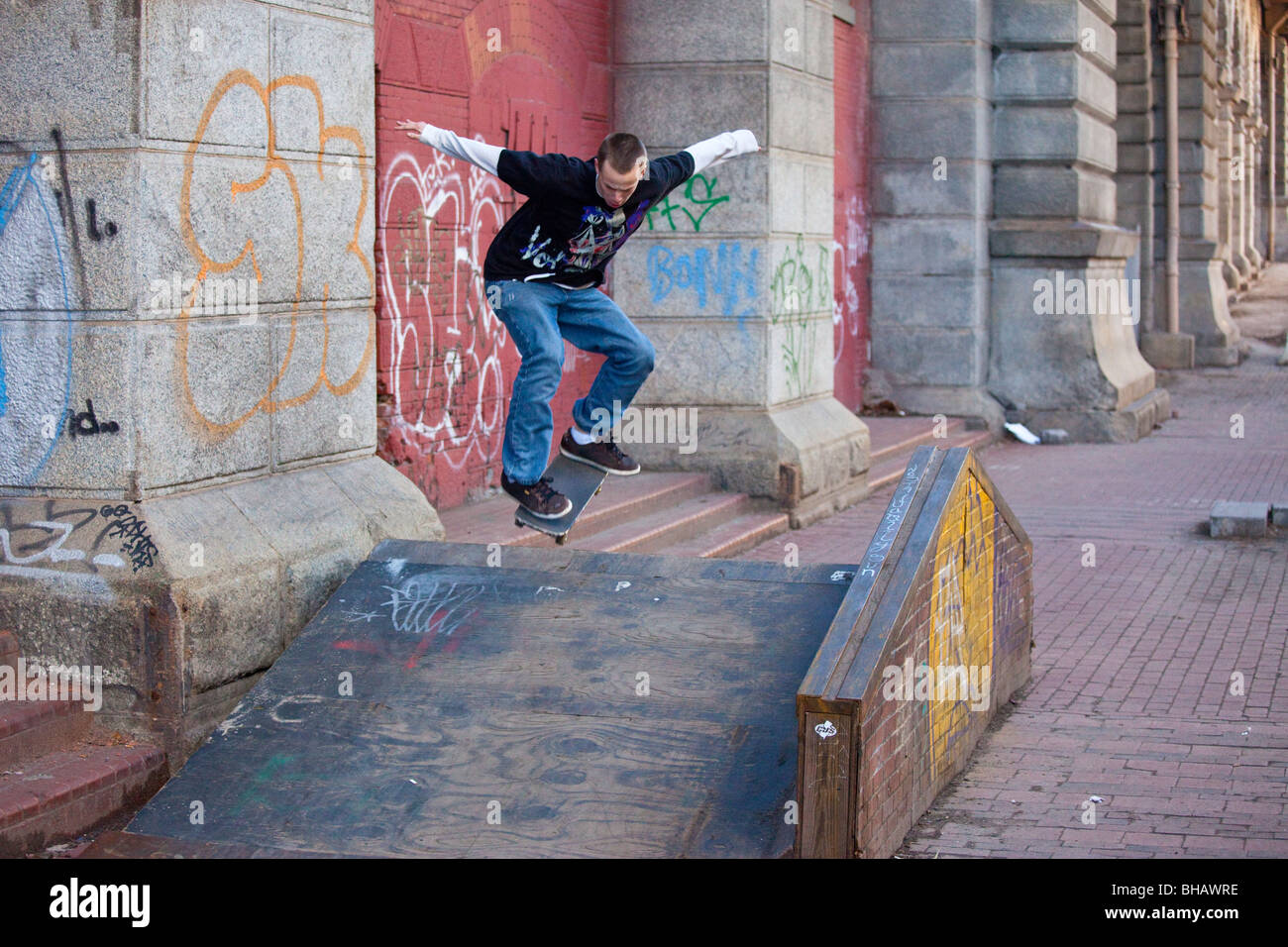 Teen doing skateboard tricks in Manhattan, New York City Stock Photo