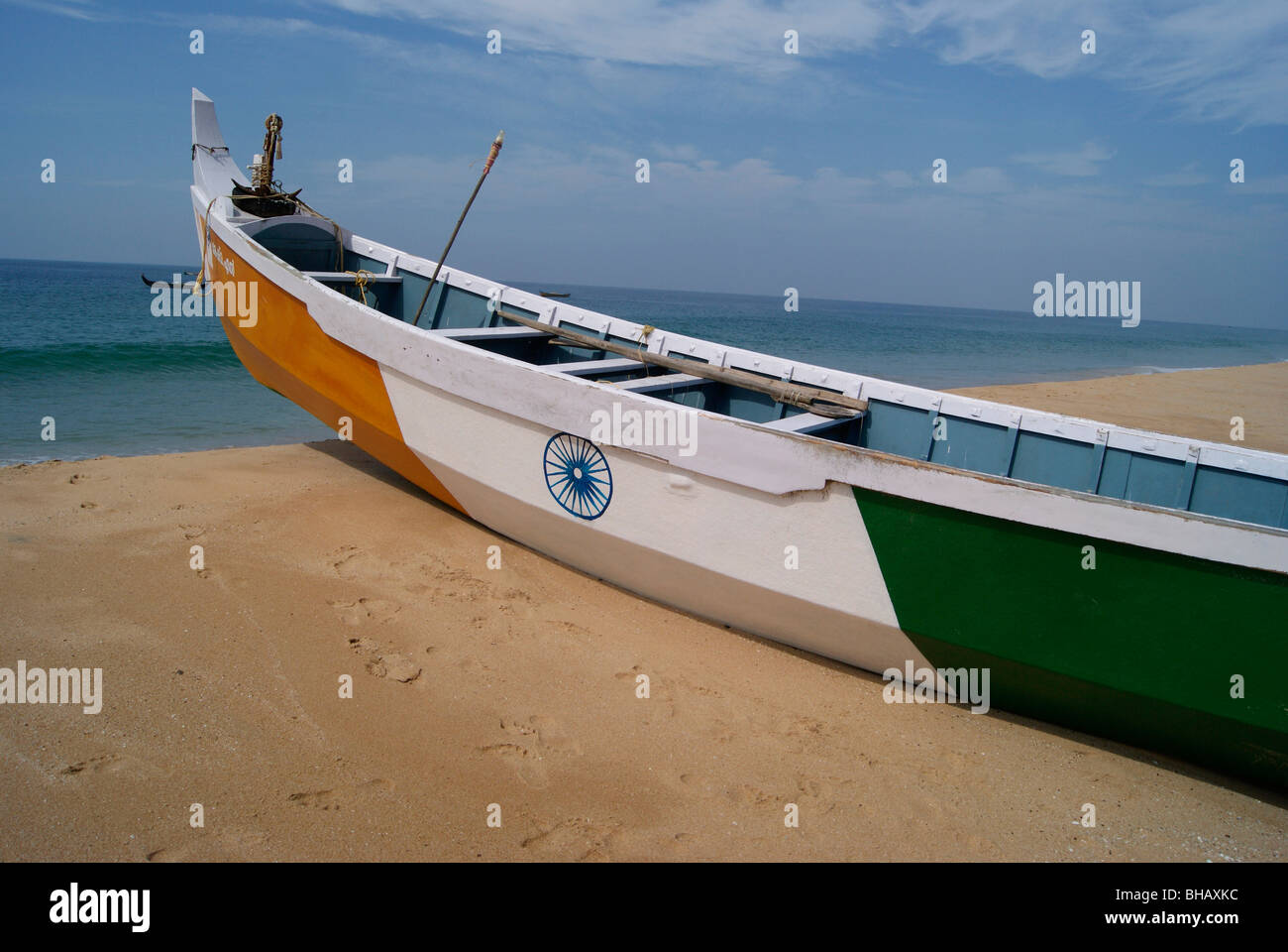 Sea Boat painted with Indian Flag in India rural coastal sea shore (Kerala Coastal region). Stock Photo