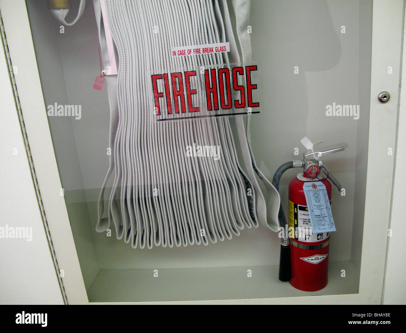 Fire hose and fire extinguisher in glass case Stock Photo 27900446 Alamy