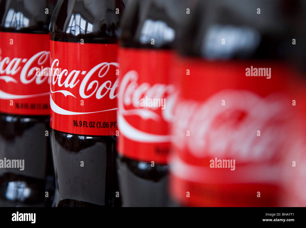 A grouping of Coca-Cola bottles.  Stock Photo