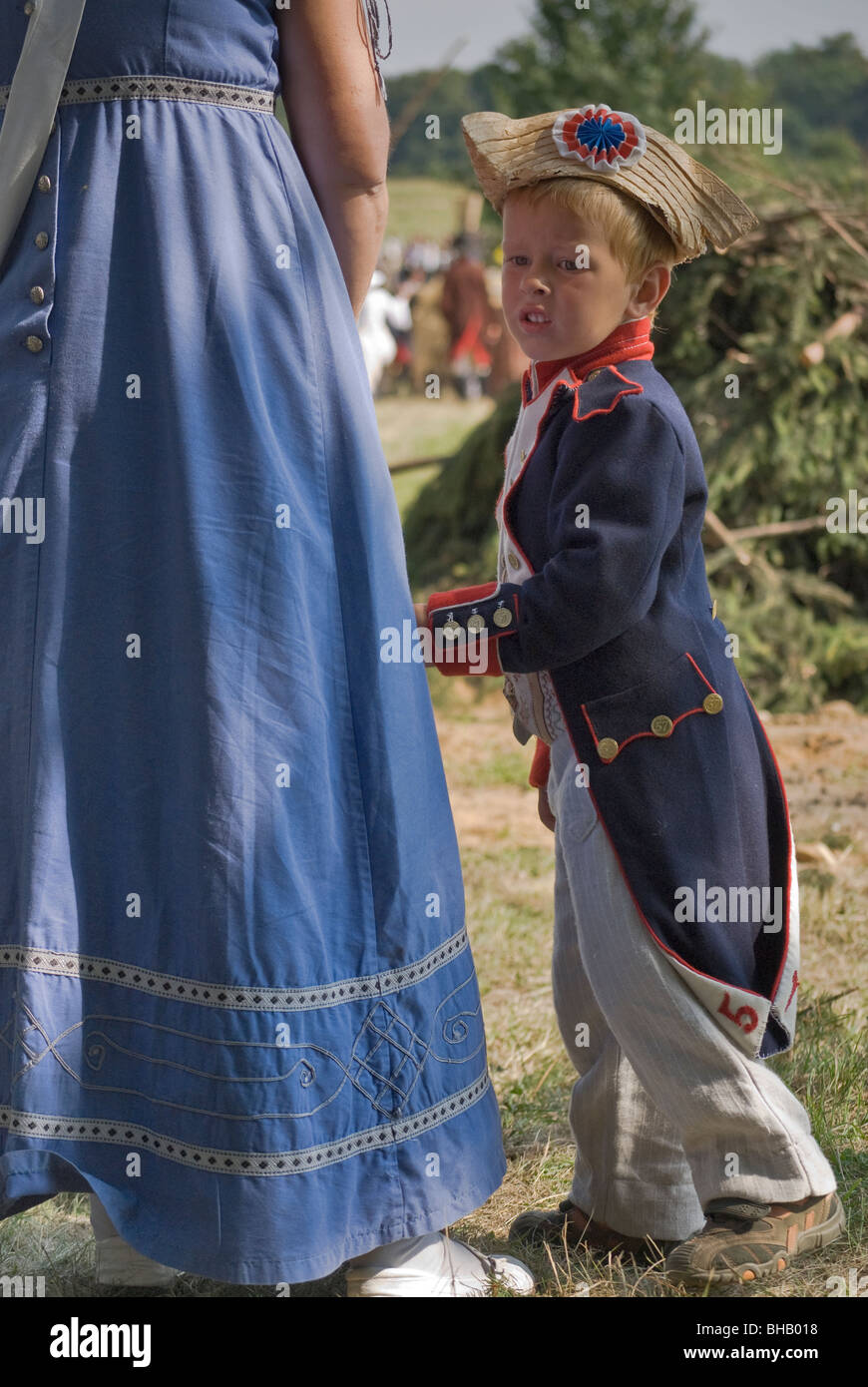 Child holding to mother's dress at Reenactment of Siege of Neisse during 1807 Napoleonic War with Prussia in Nysa, Poland Stock Photo