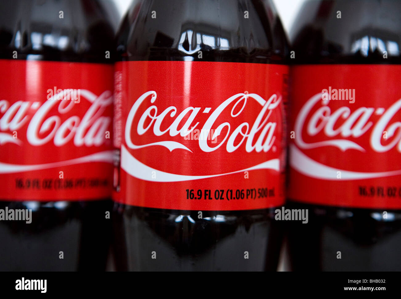 A grouping of Coca-Cola bottles.  Stock Photo