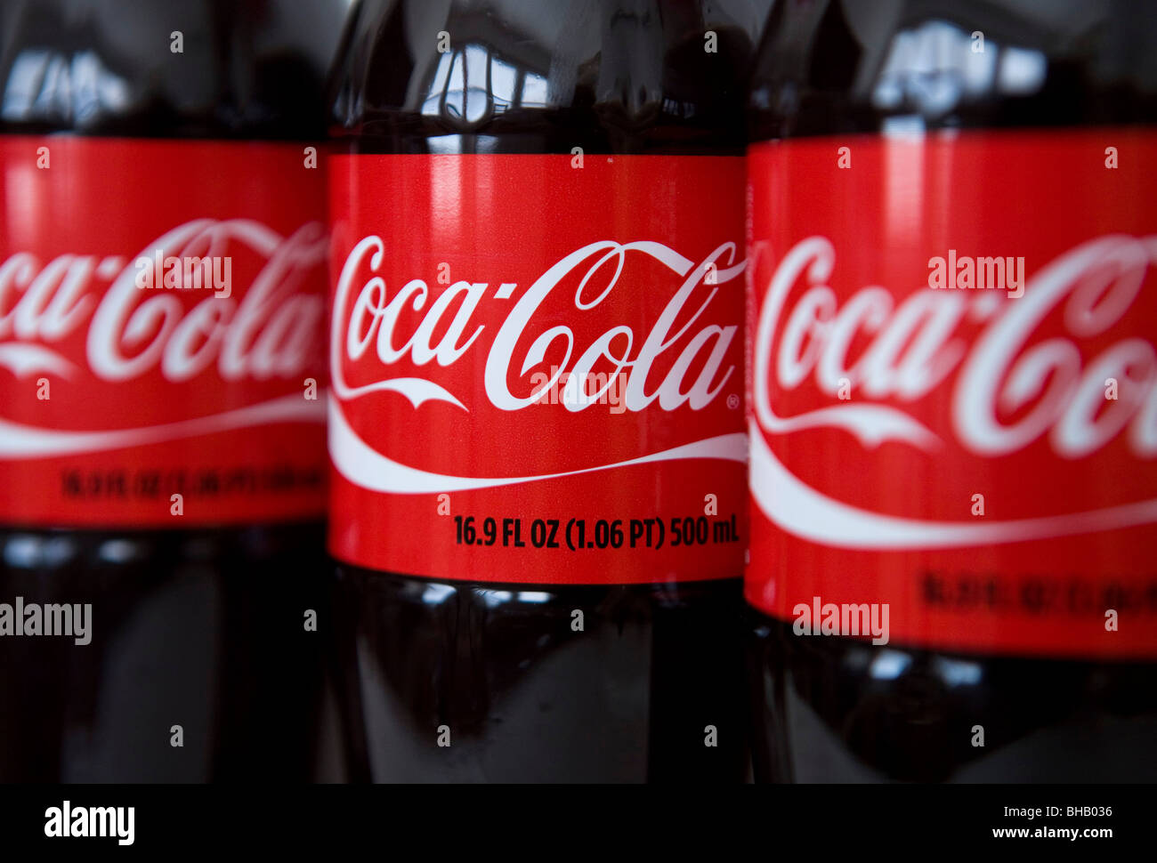 A grouping of Coca-Cola bottles.  Stock Photo
