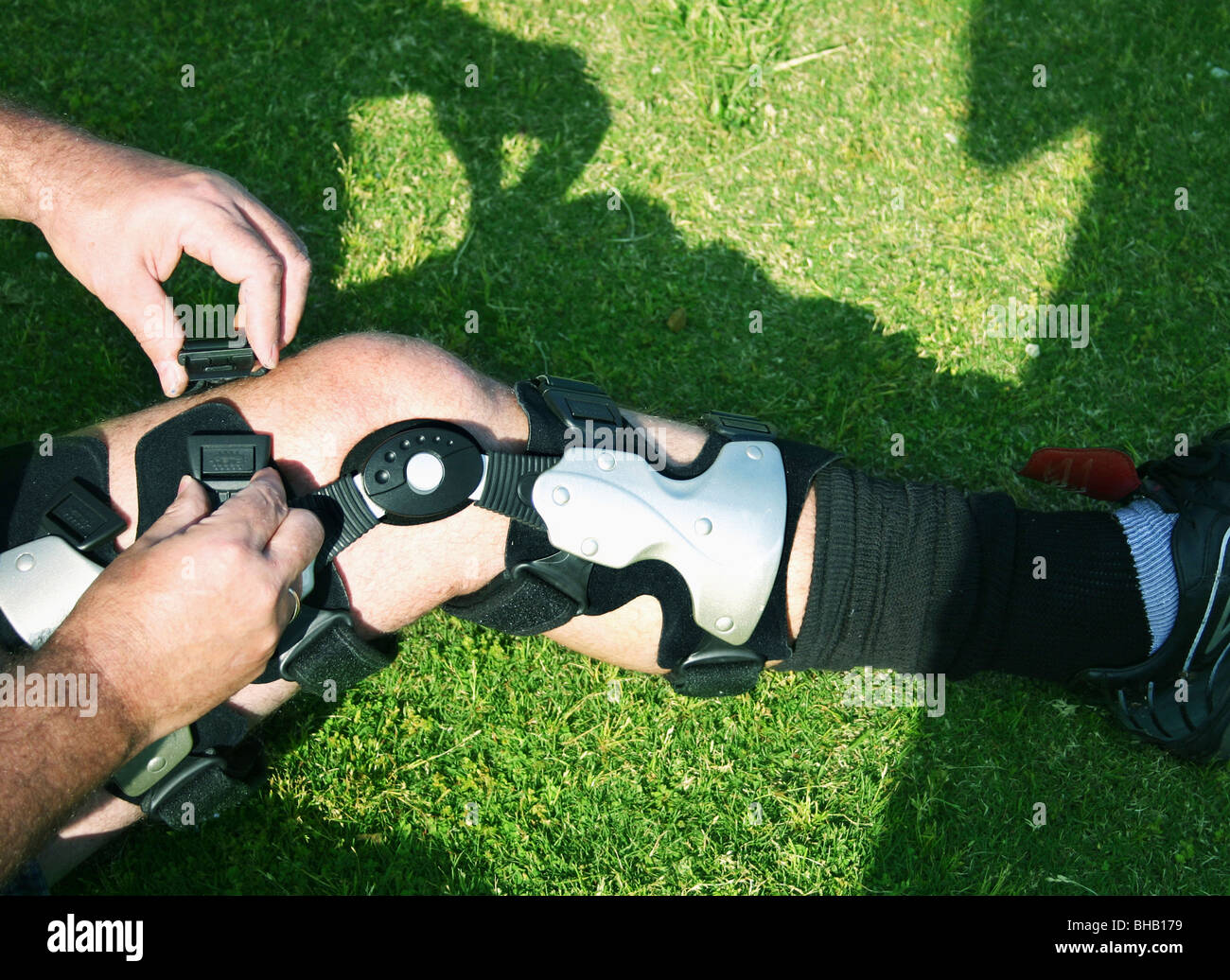 Football player adjust knee brace before playing game Stock Photo Alamy