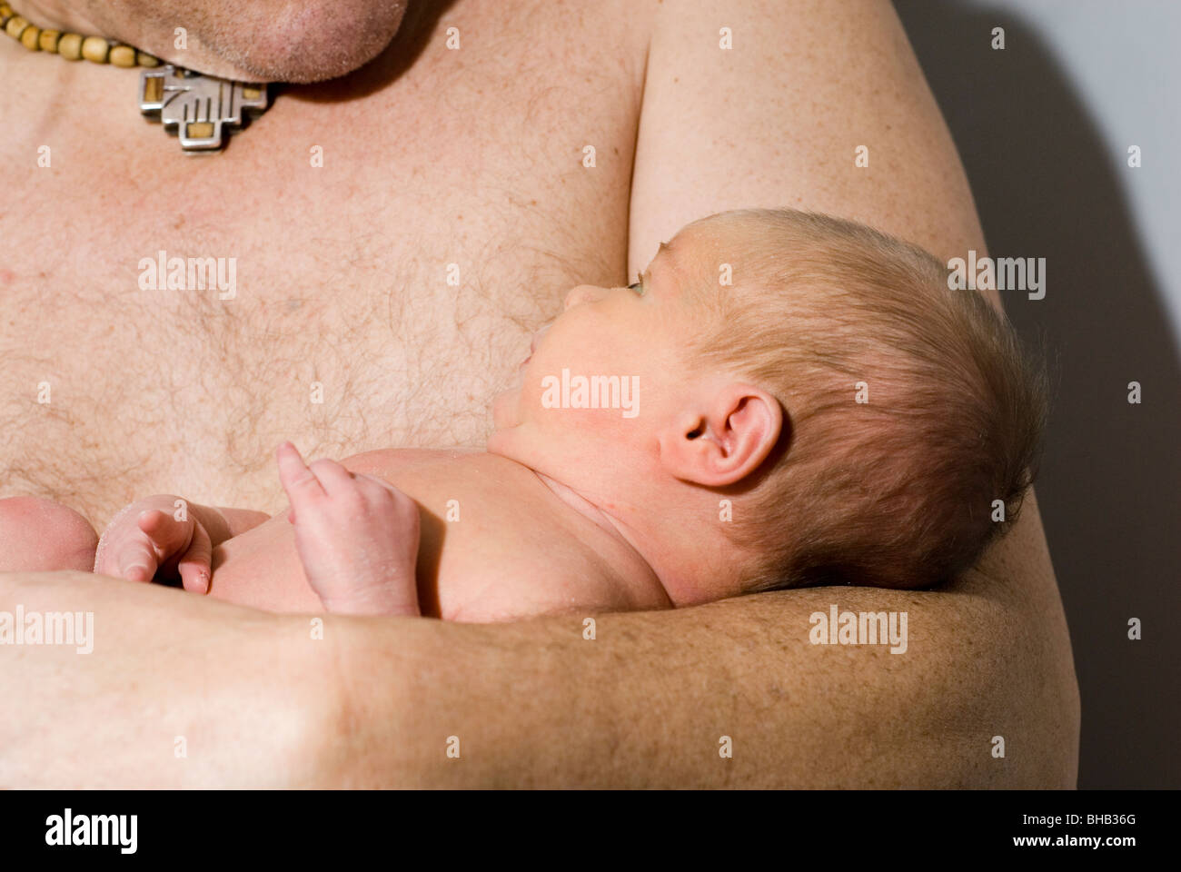 Close Up On Newborn Baby Cradled In Father S Arms Aged 13 Days Stock Photo Alamy