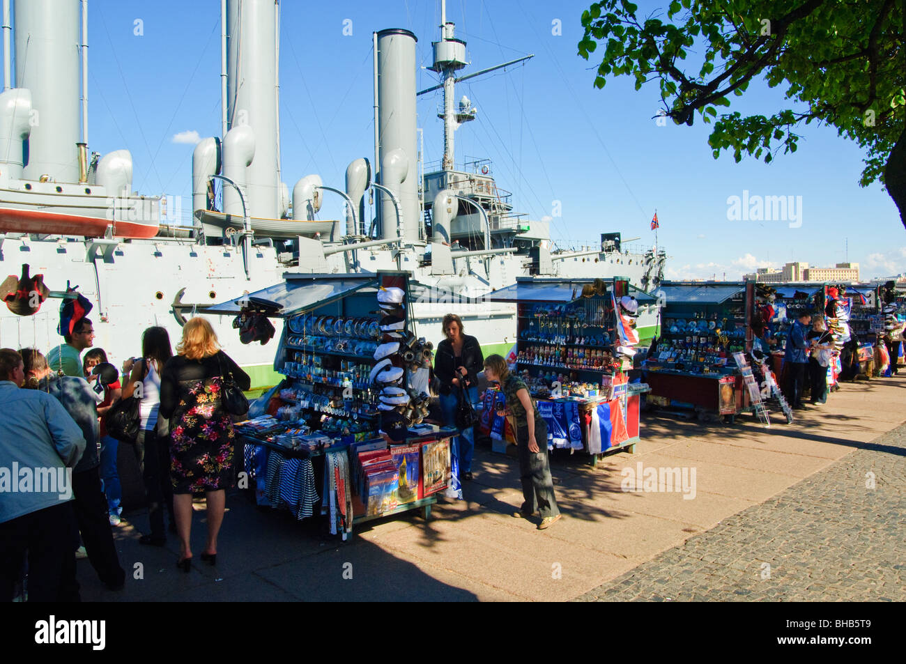 Souvenir stalls beside the Cruiser Aurora, famous for firing the shot which launched the Revolution, St Petersburg, Russia Stock Photo