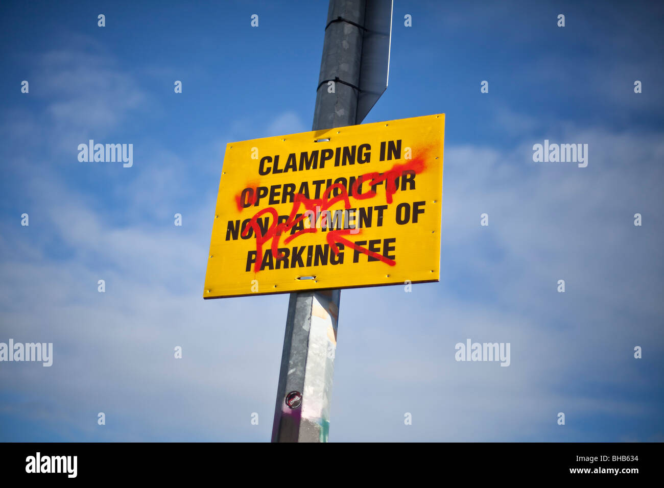 Clamping in operation sight with graffiti sprayed on it against a blue sky Stock Photo