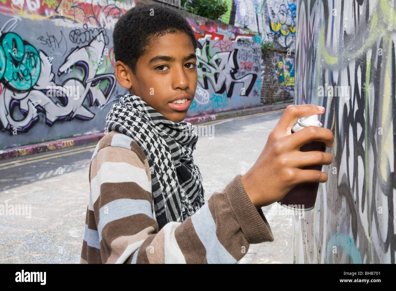 Male Teen Painting Wall Spray Paint High Resolution Stock Photography