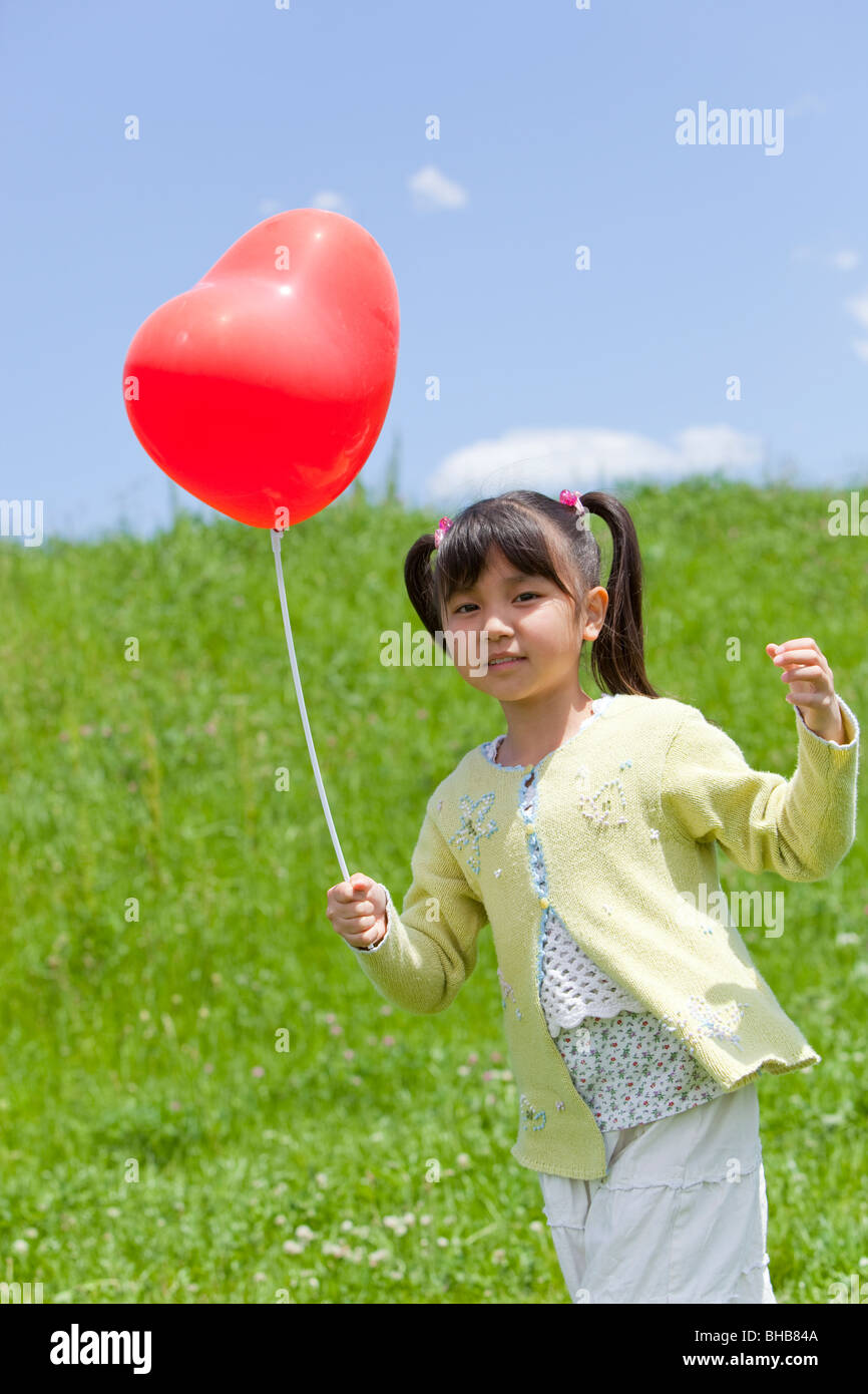 Girl 8 9 holding balloon hi-res stock photography and images - Alamy