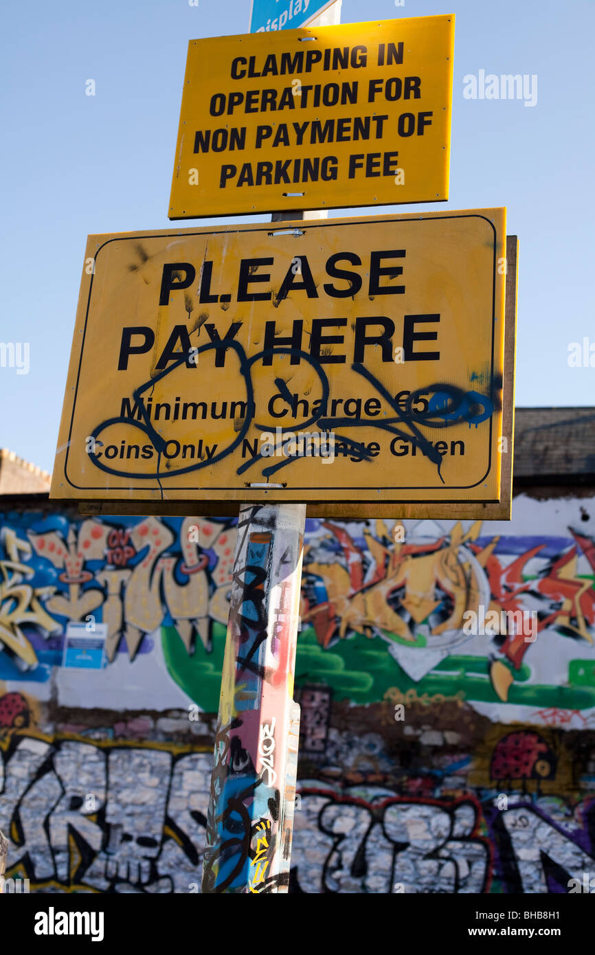 Clamping and please pay here sign in a graffiti park that has been defaced Stock Photo