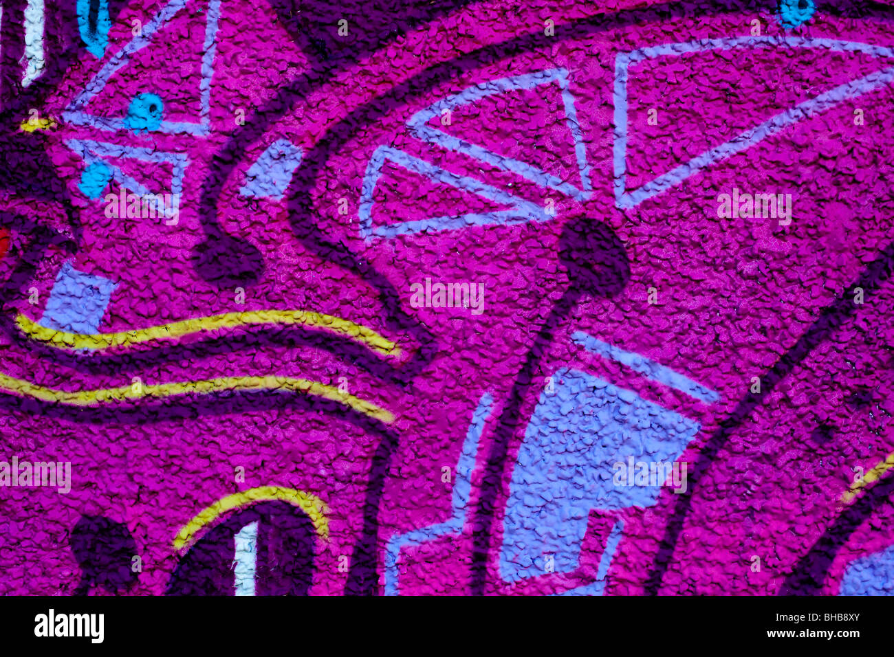 Close up of graffiti spray painted on to a wall in a city to create an ...