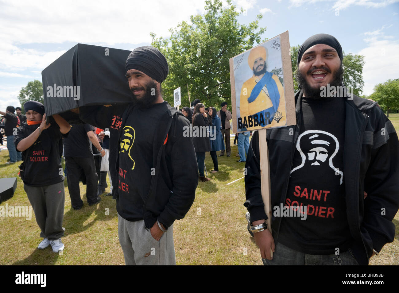 Sikhs mark the 25th anniversary of Amritsar massacres and call for a Sikh state. Young men with coffins & Babbar placard Stock Photo