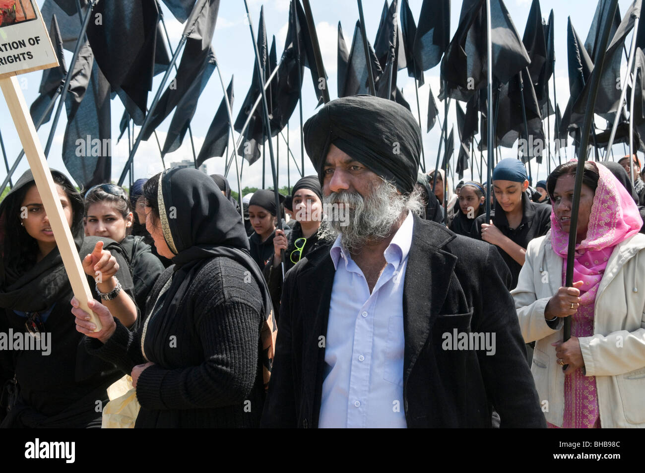 Sikhs mark the 25th anniversary of Amritsar massacres by Indian army and call for an Sikh state. Marchers & black flags Stock Photo