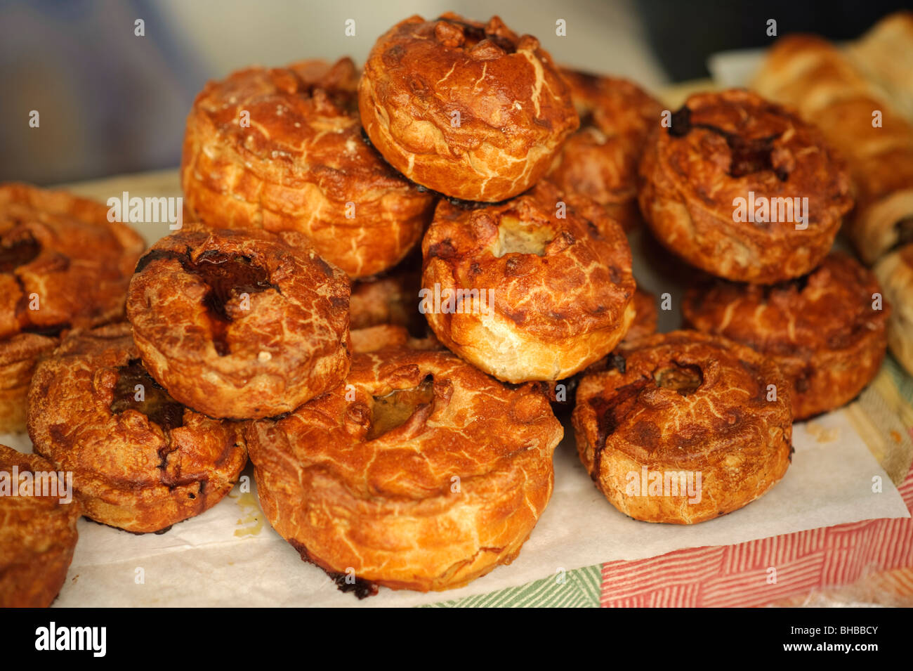 Stack of freshly made organic pork pies on sale at Aberystwyth Farmers Market, Ceredigion Wales UK Stock Photo