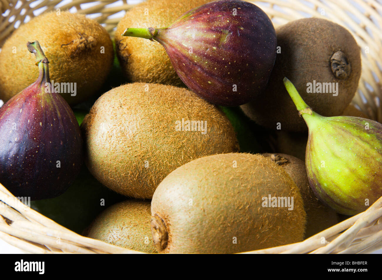 Kiwifruits and Figs in a basket Stock Photo