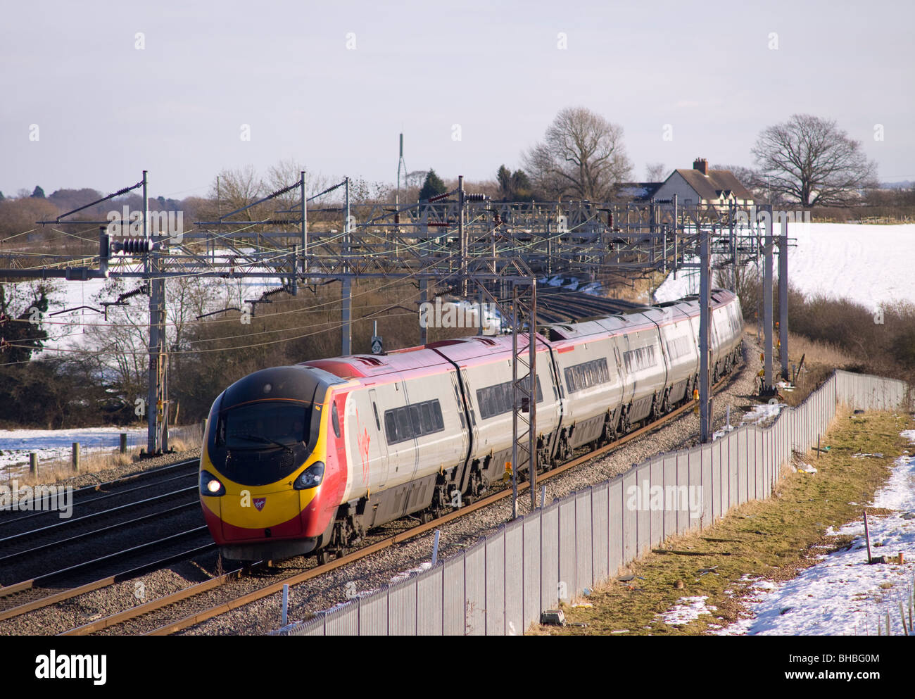Virgin Pendolino tilting train heads north along the West Coat mainline near Soulbury in Buckinghamshire Stock Photo