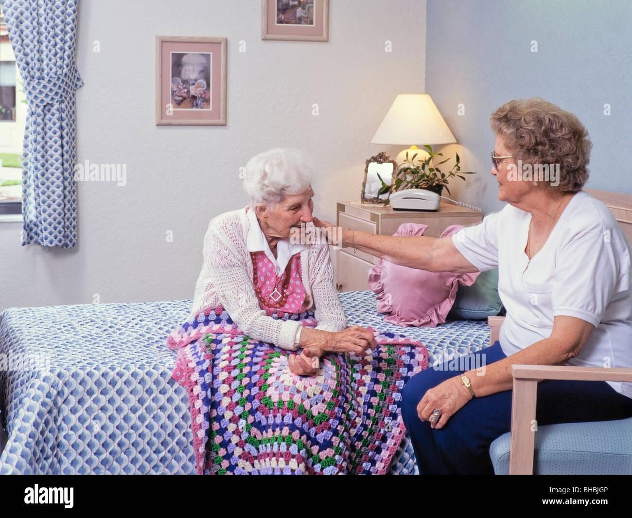 Elderly woman in nursing home with visitor Stock Photo