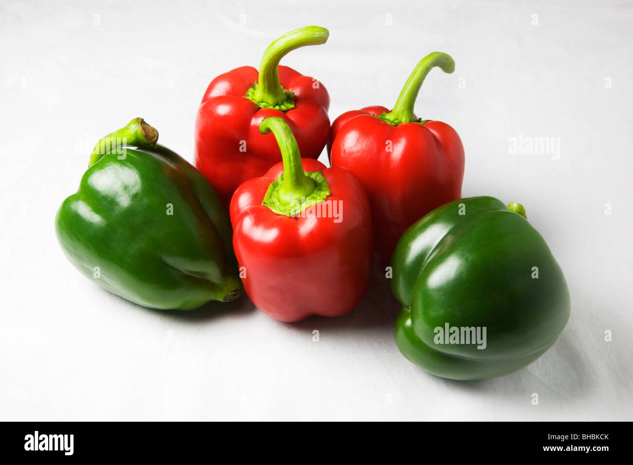 Red and Green Peppers on a White Background Stock Photo